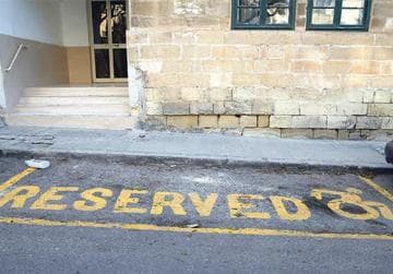 Reserved parking bay with yellow markings — do not park